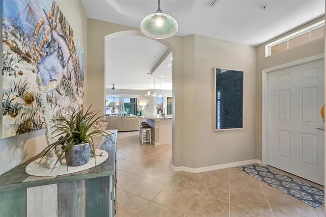 a kitchen with stainless steel appliances granite countertop a refrigerator a stove a sink a dining table and chairs