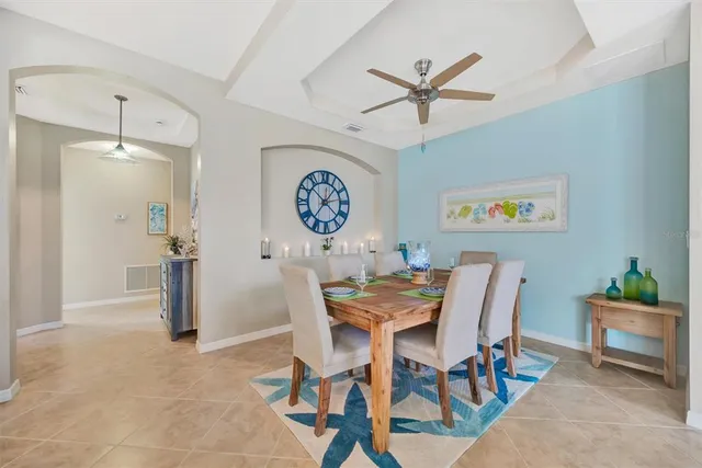 a living room with lots of furniture and kitchen view
