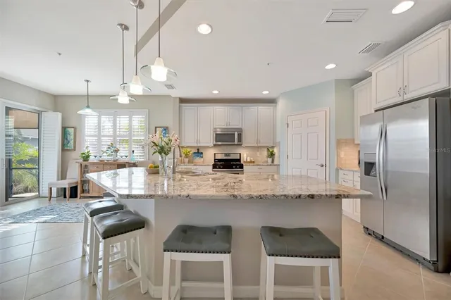 a living room with furniture a flat screen tv and a floor to ceiling window