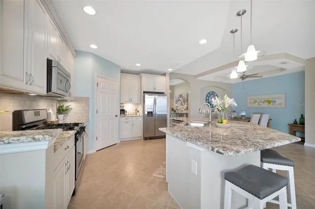 a living room with large windows and a table