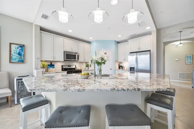 a view of a hallway with wooden floor and a living room
