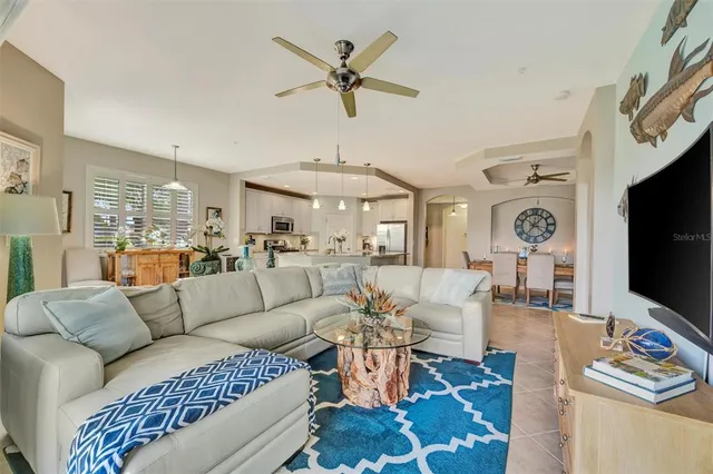 a front view of a house with garden and a pond