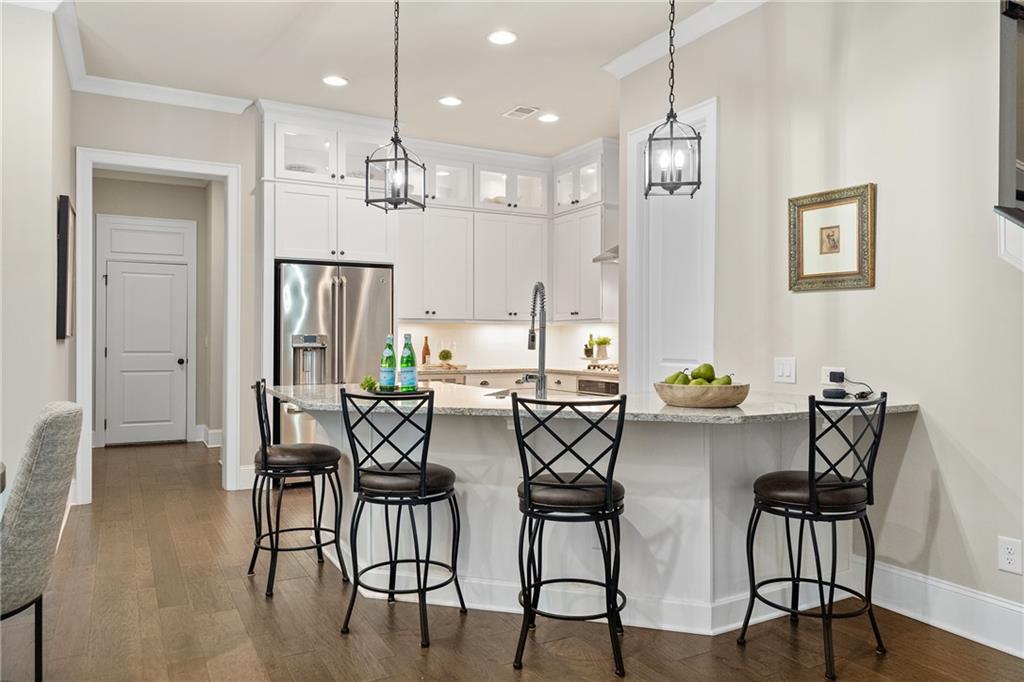98 Academy Street Alpharetta, GA 30009 - Photo 12 of 56 a view of a dining room with furniture and wooden floor