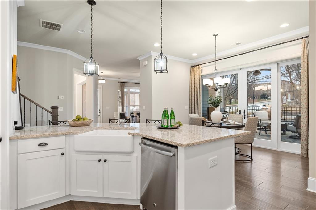 98 Academy Street Alpharetta, GA 30009 - Photo 13 of 56 a kitchen with sink stove and wooden floor
