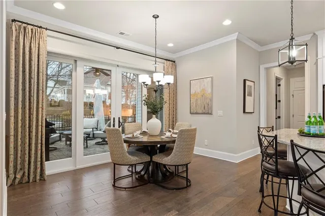 a dining room with furniture window and wooden floor