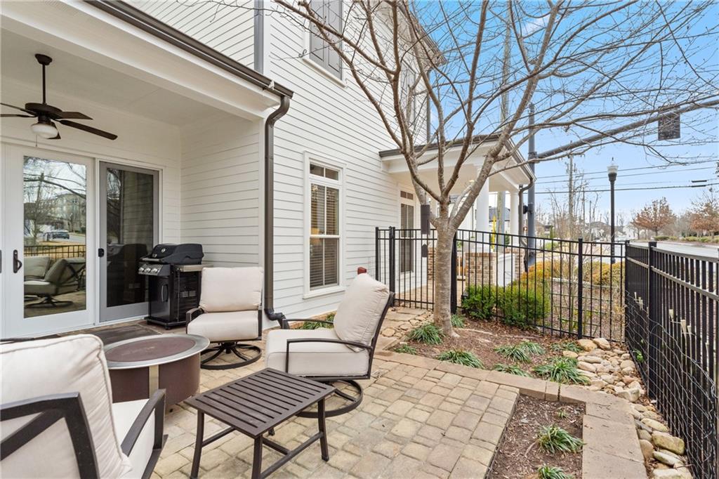 98 Academy Street Alpharetta, GA 30009 - Photo 17 of 56 a view of balcony with chairs potted plant and a large window