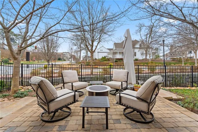 a view of a patio with couches chairs and a fire pit