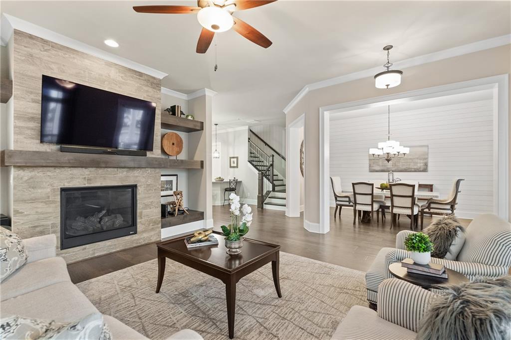 98 Academy Street Alpharetta, GA 30009 - Photo 20 of 56 a living room with furniture a flat screen tv and a fireplace
