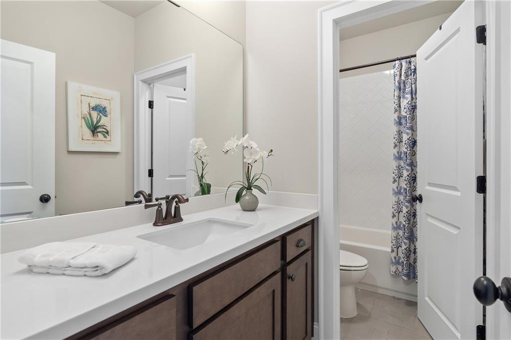 98 Academy Street Alpharetta, GA 30009 - Photo 29 of 56 a bathroom with a granite countertop sink toilet and shower