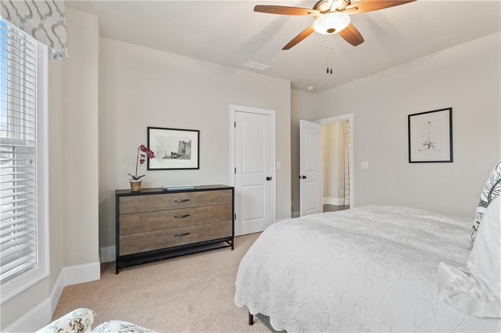 98 Academy Street Alpharetta, GA 30009 - Photo 30 of 56 a bedroom with a bed and a chandelier