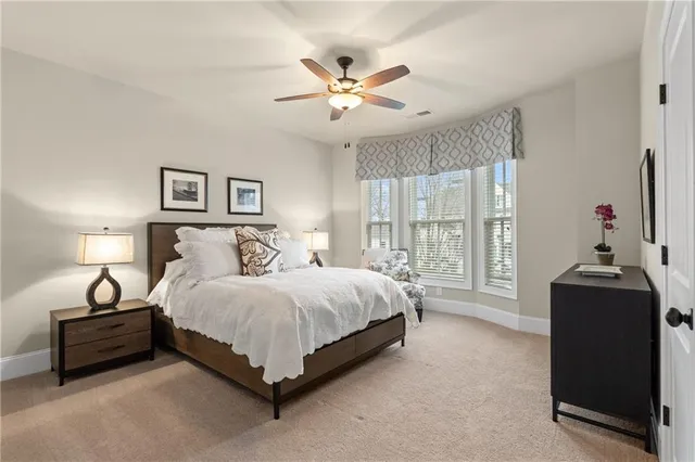 a spacious bedroom with a bed and a chandelier