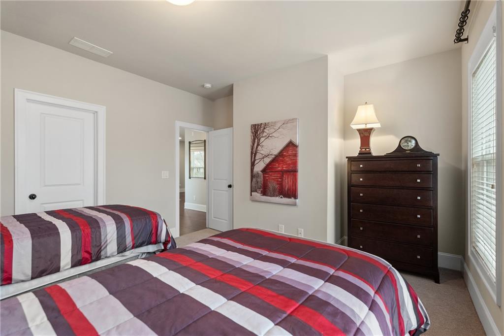 98 Academy Street Alpharetta, GA 30009 - Photo 32 of 56 a bedroom with two bed and painting on the wall