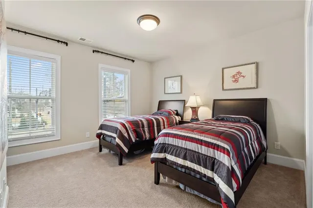 a bedroom with two beds and a window