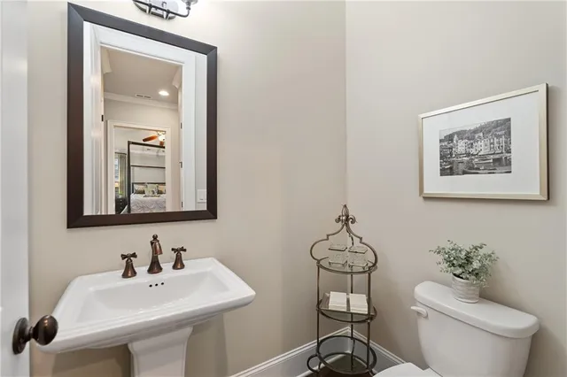 a bathroom with a toilet a sink and mirror