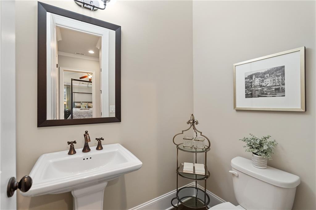 98 Academy Street Alpharetta, GA 30009 - Photo 35 of 56 a bathroom with a toilet a sink and mirror