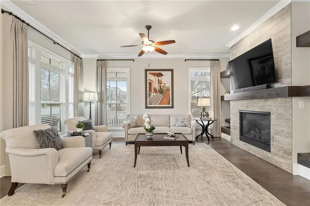 a living room with furniture a fireplace and a flat screen tv