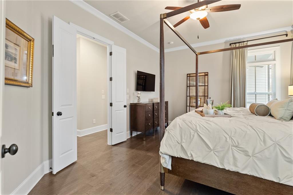 98 Academy Street Alpharetta, GA 30009 - Photo 7 of 56 a bedroom with a bed and a flat tv screen on dresser