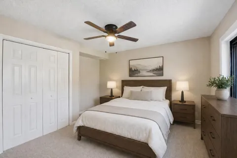 a bedroom with a large bed and a chandelier