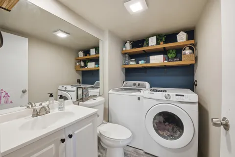 a utility room with dryer washer and a sink