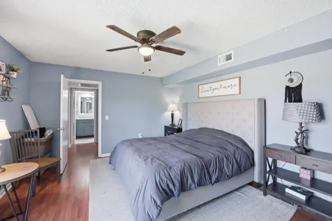 a bedroom with a large bed and a chandelier