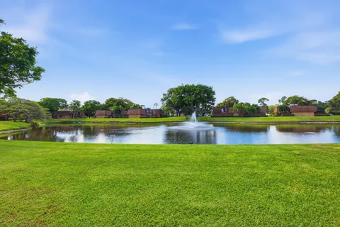 a view of a lake with houses in the background