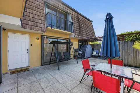 a view of a patio with a table and chairs