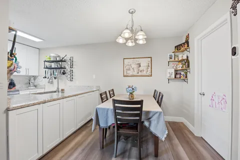 a view of a dining room with furniture and chandelier