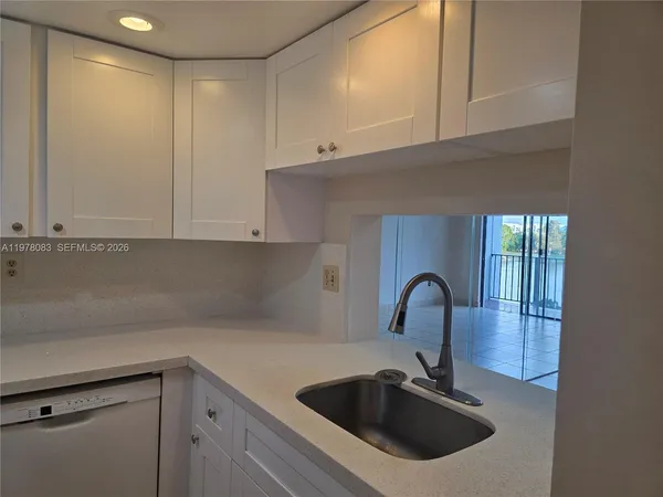 a kitchen with a sink and cabinets