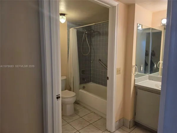 a bathroom with a shower a mirror and a sink