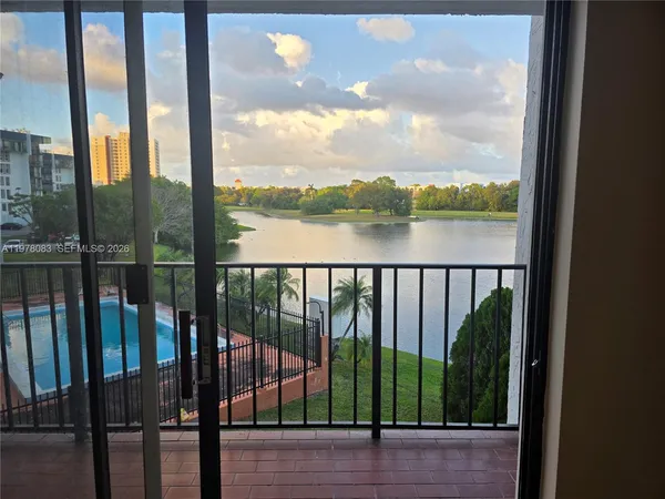 a view of a swimming pool and lake from nearby houses