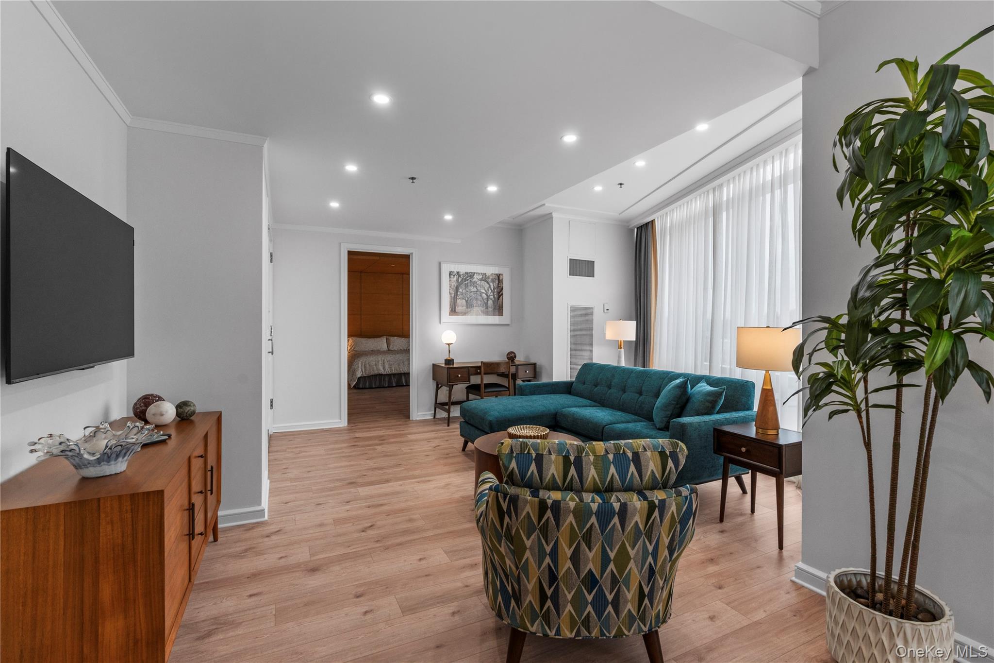 1 Renaissance Square, Unit 10H White Plains, NY 10601 - Photo 3 of 22 a living room with furniture and a flat screen tv