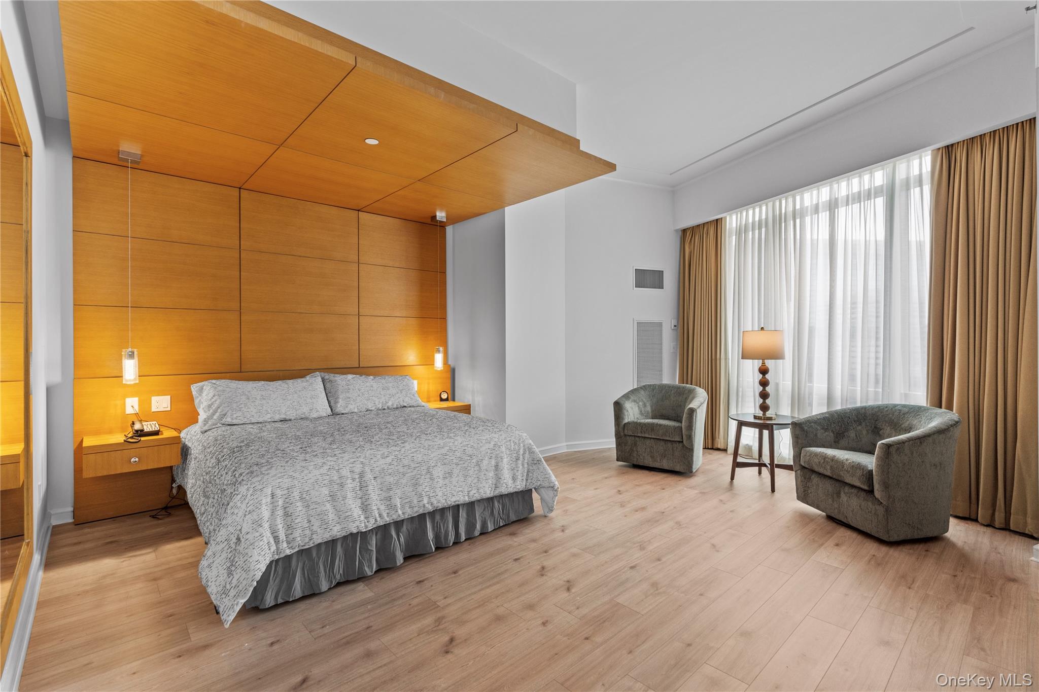 1 Renaissance Square, Unit 10H White Plains, NY 10601 - Photo 6 of 22 a bedroom with a bed and a couch next to a window