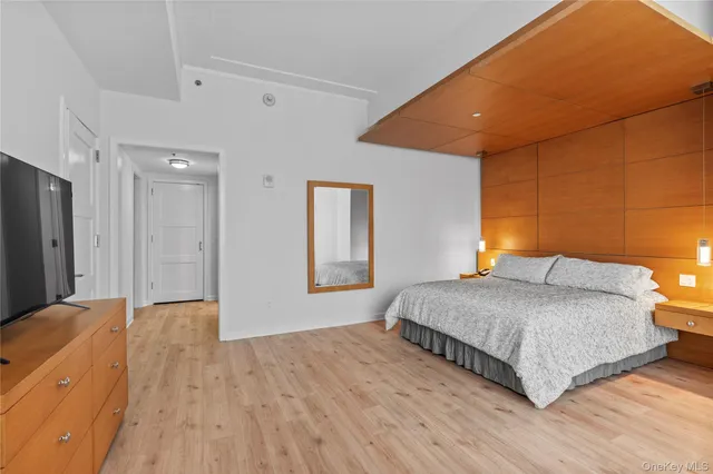 a bedroom with a bed and a dresser