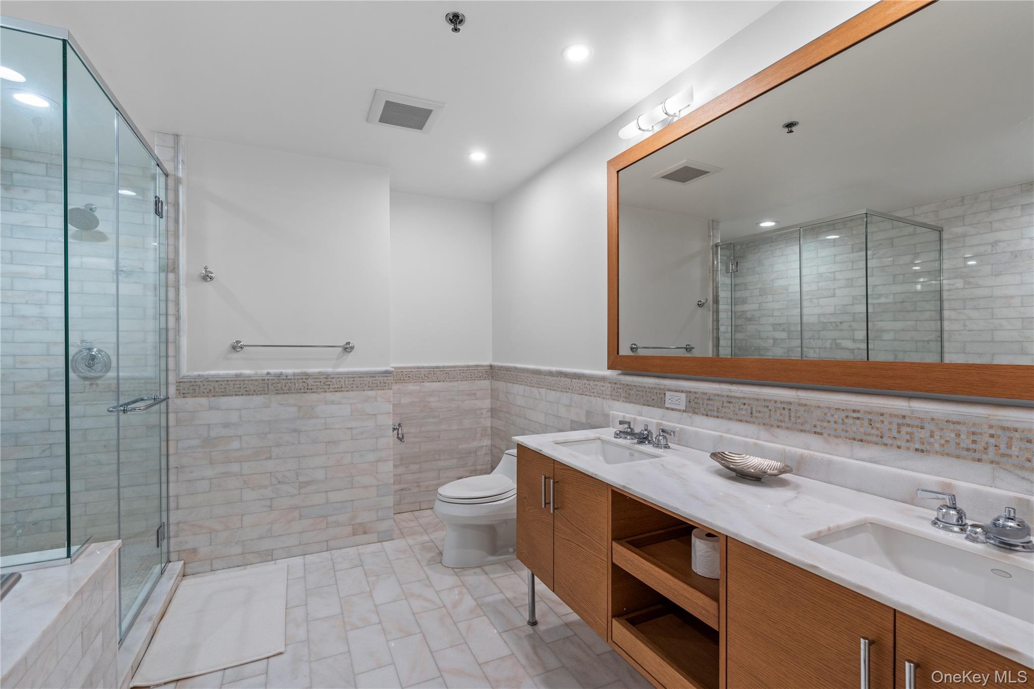 1 Renaissance Square, Unit 10H White Plains, NY 10601 - Photo 9 of 22 a bathroom with a sink a toilet and shower
