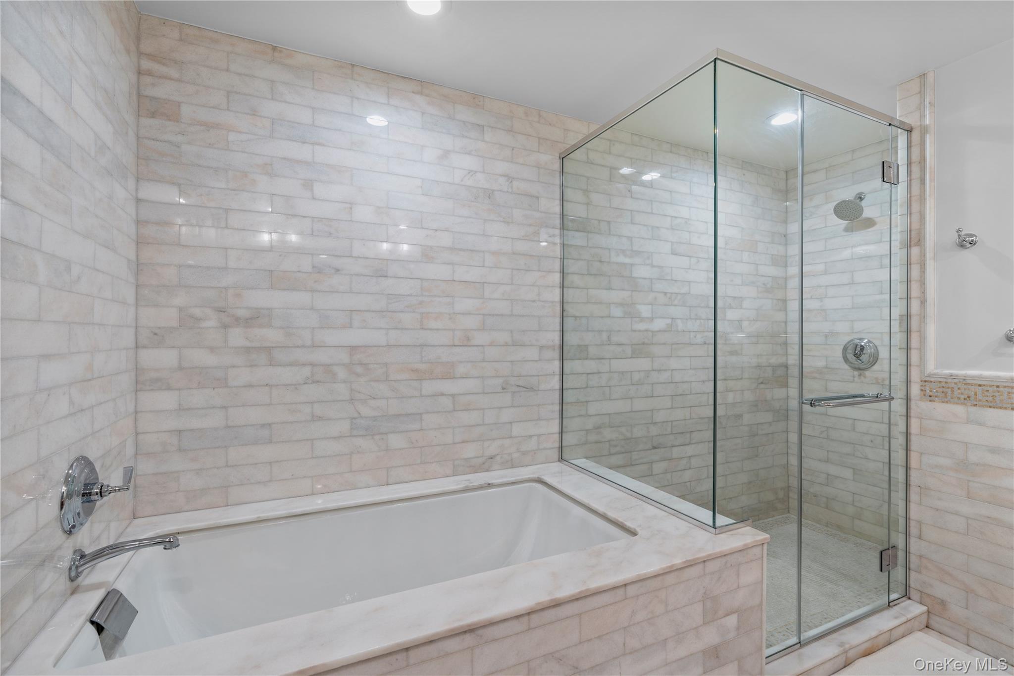 1 Renaissance Square, Unit 10H White Plains, NY 10601 - Photo 10 of 22 a bathroom with a bathtub and a shower