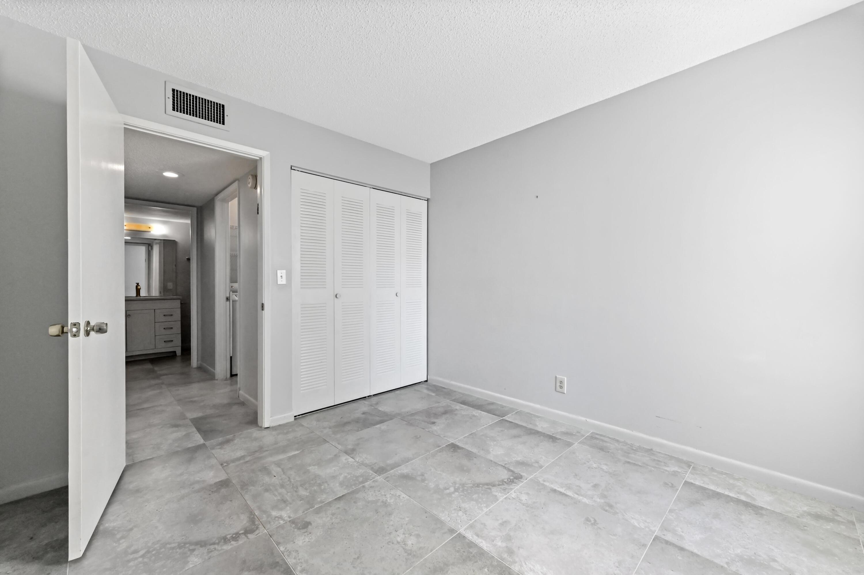 14895 Builtmore Way, Unit 107 Delray Beach, FL 33446 - Photo 16 of 40 an empty room with a bathroom