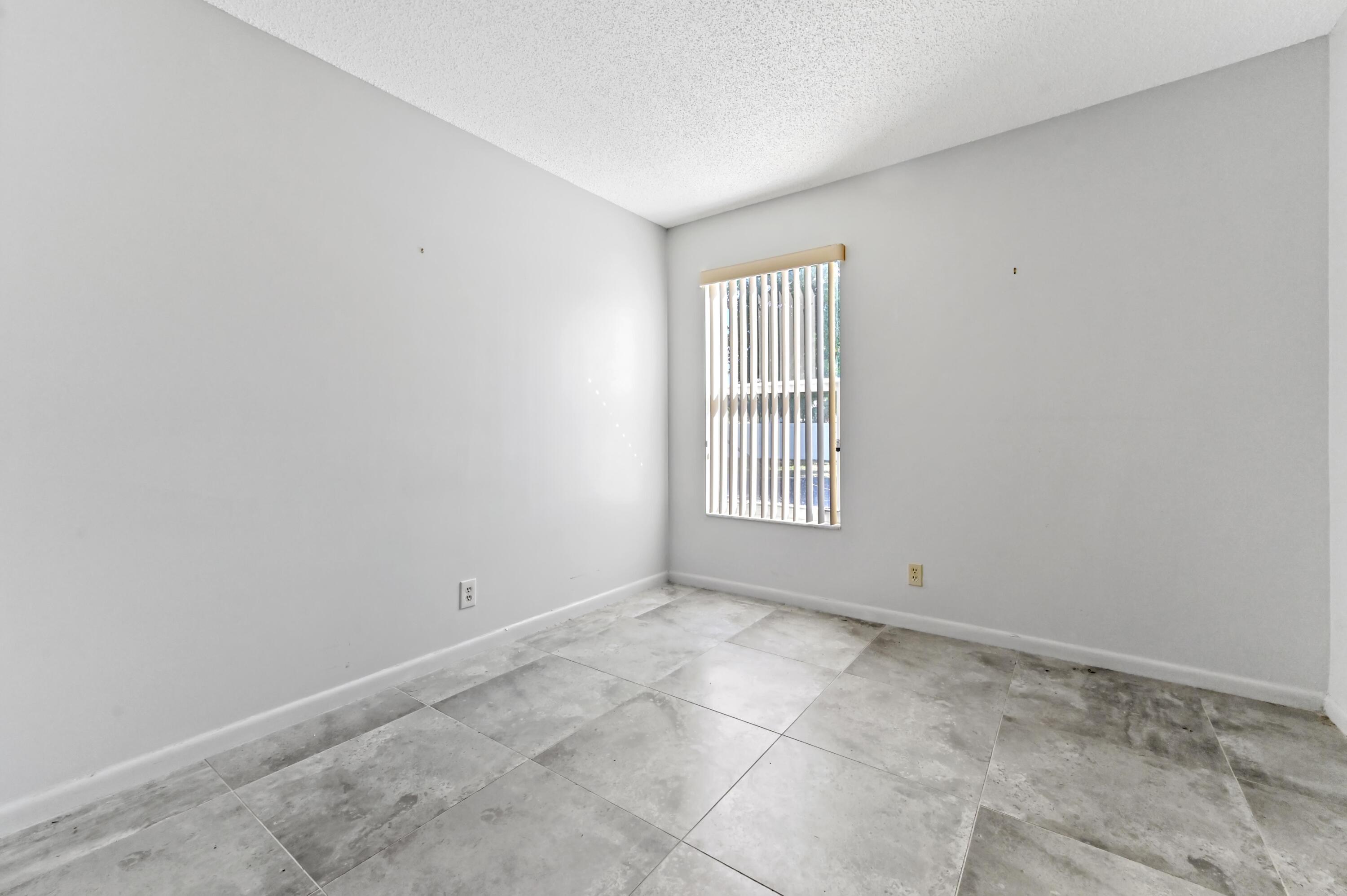 14895 Builtmore Way, Unit 107 Delray Beach, FL 33446 - Photo 17 of 40 a view of an empty room with a window