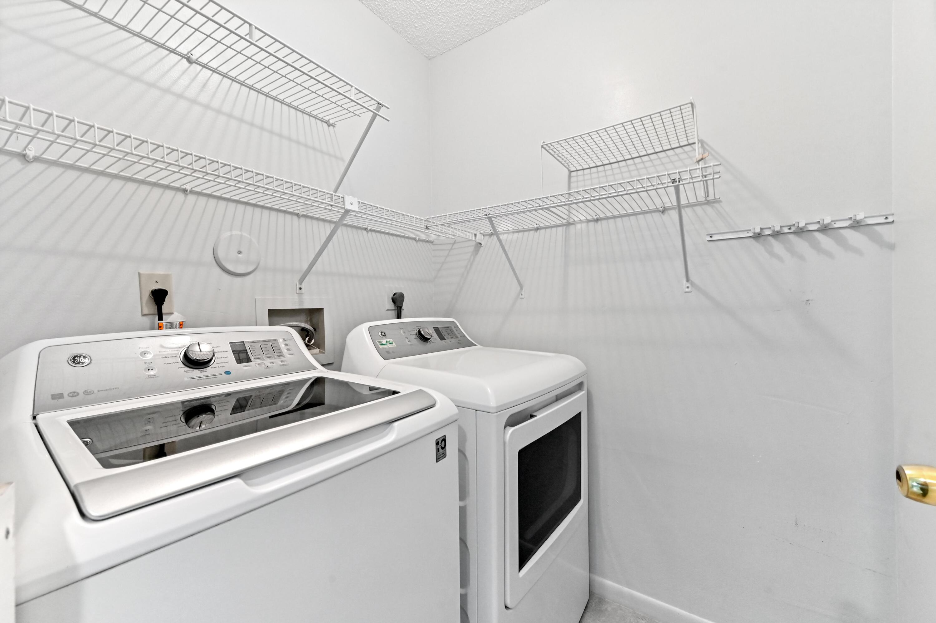 14895 Builtmore Way, Unit 107 Delray Beach, FL 33446 - Photo 21 of 40 a utility room with dryer and washer