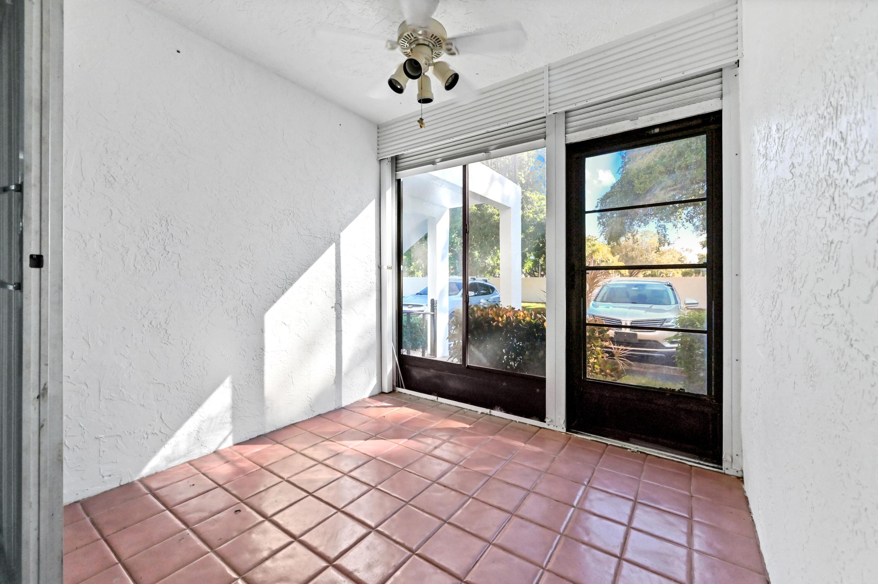 14895 Builtmore Way, Unit 107 Delray Beach, FL 33446 - Photo 22 of 40 a bedroom with a bed and a window