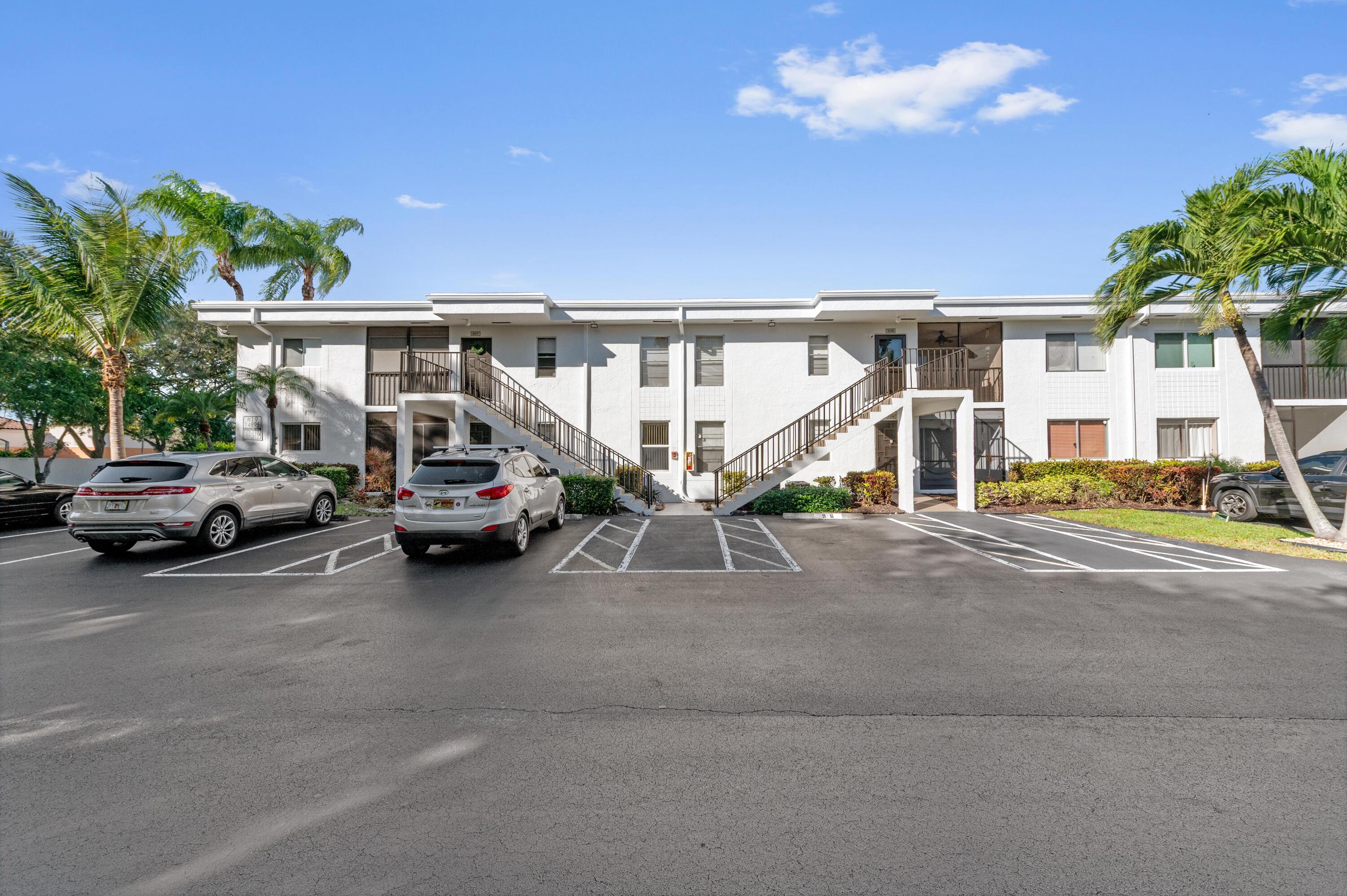 14895 Builtmore Way, Unit 107 Delray Beach, FL 33446 - Photo 24 of 40 a view of a cars park in front of house