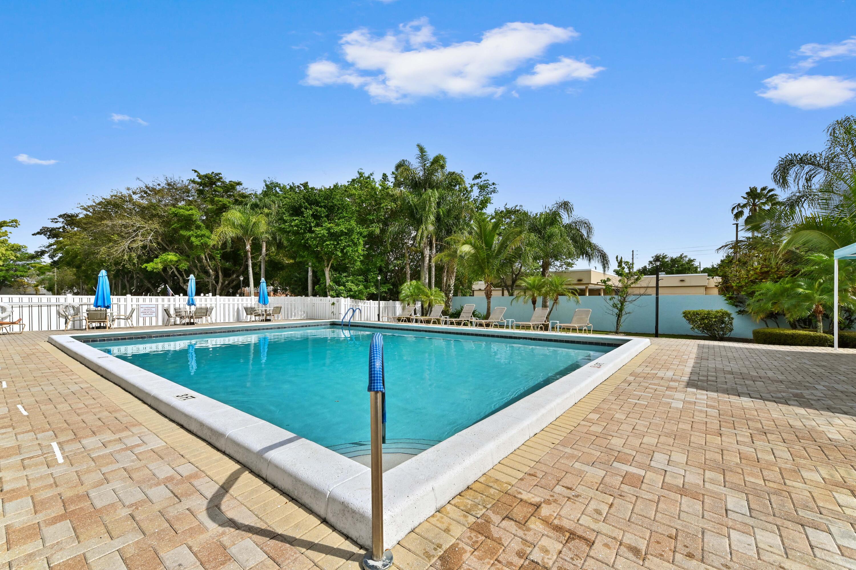 14895 Builtmore Way, Unit 107 Delray Beach, FL 33446 - Photo 26 of 40 a view of a backyard with swimming pool