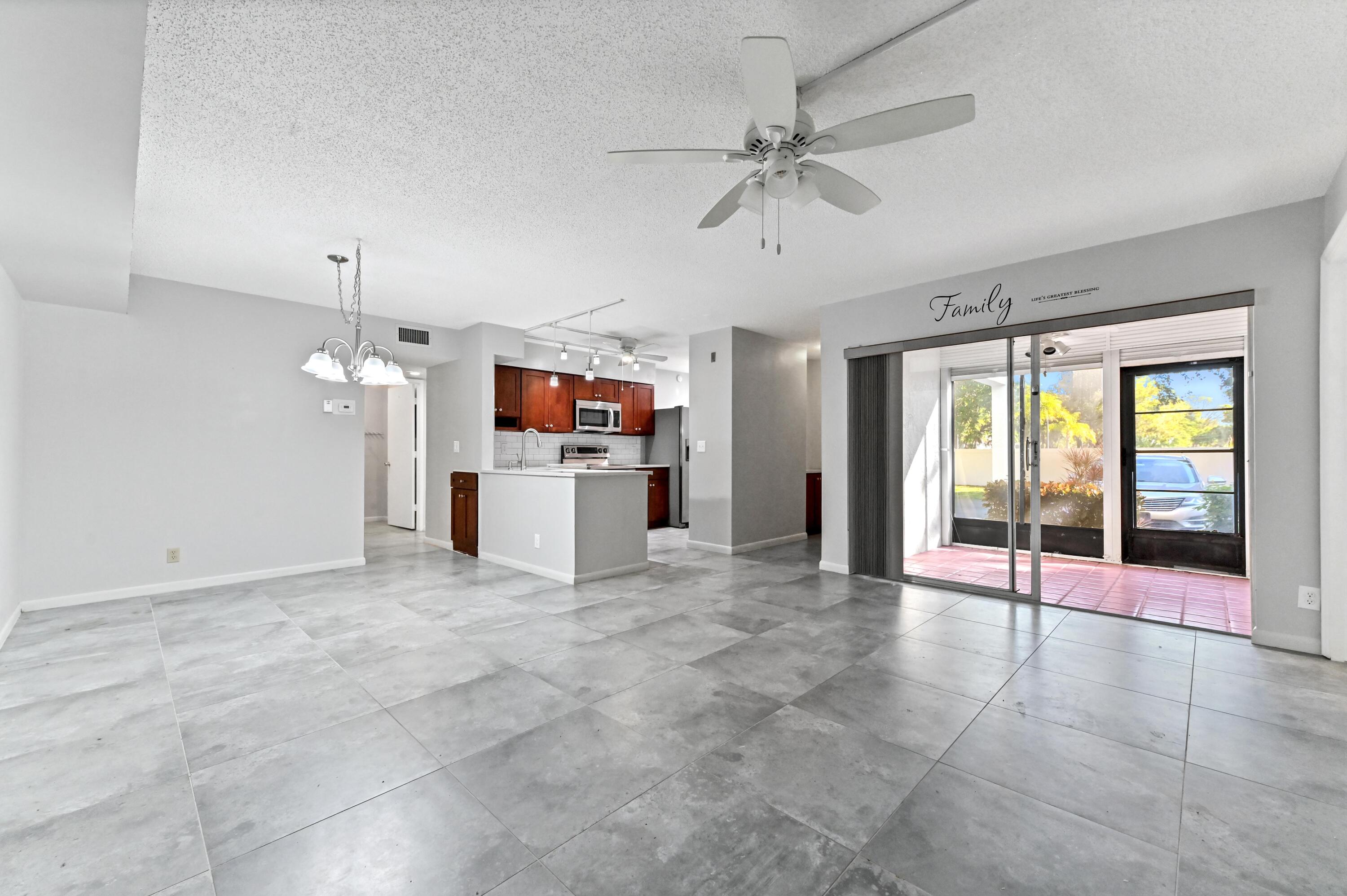 14895 Builtmore Way, Unit 107 Delray Beach, FL 33446 - Photo 3 of 40 a view of kitchen with furniture electronic appliances and window