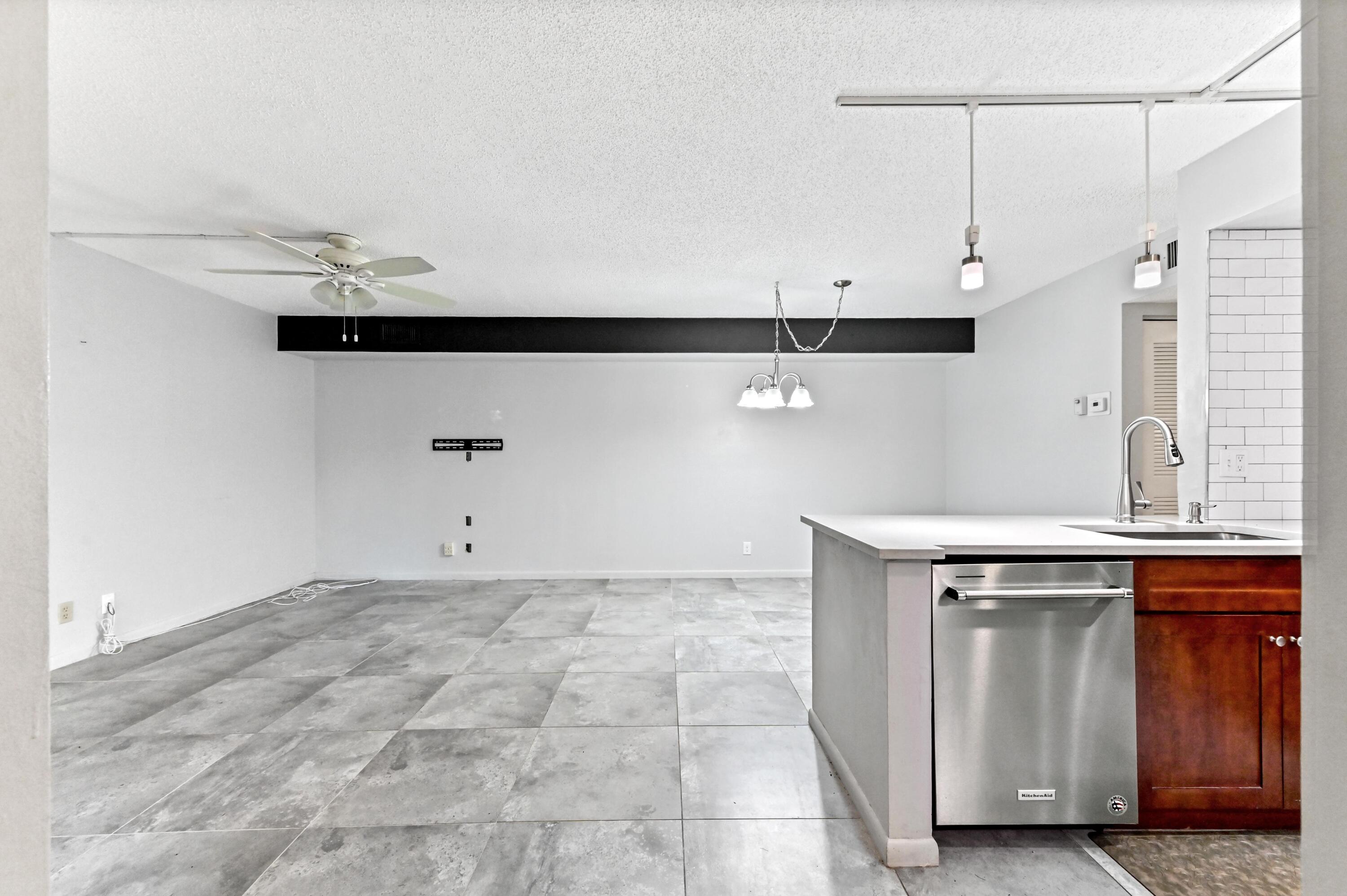 14895 Builtmore Way, Unit 107 Delray Beach, FL 33446 - Photo 5 of 40 a view of a kitchen with a sink and a window