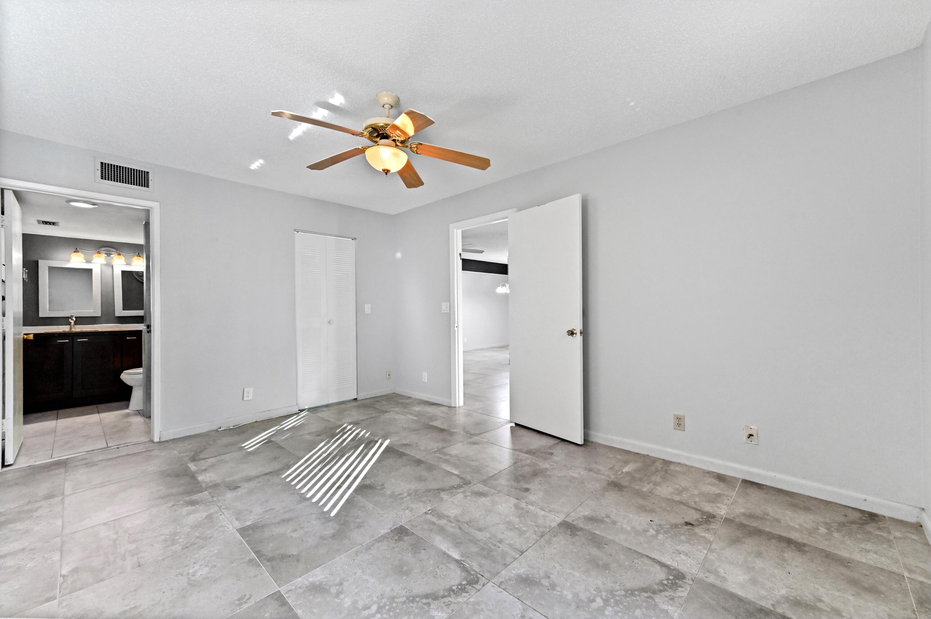 14895 Builtmore Way, Unit 107 Delray Beach, FL 33446 - Photo 7 of 40 a view of an empty room and kitchen