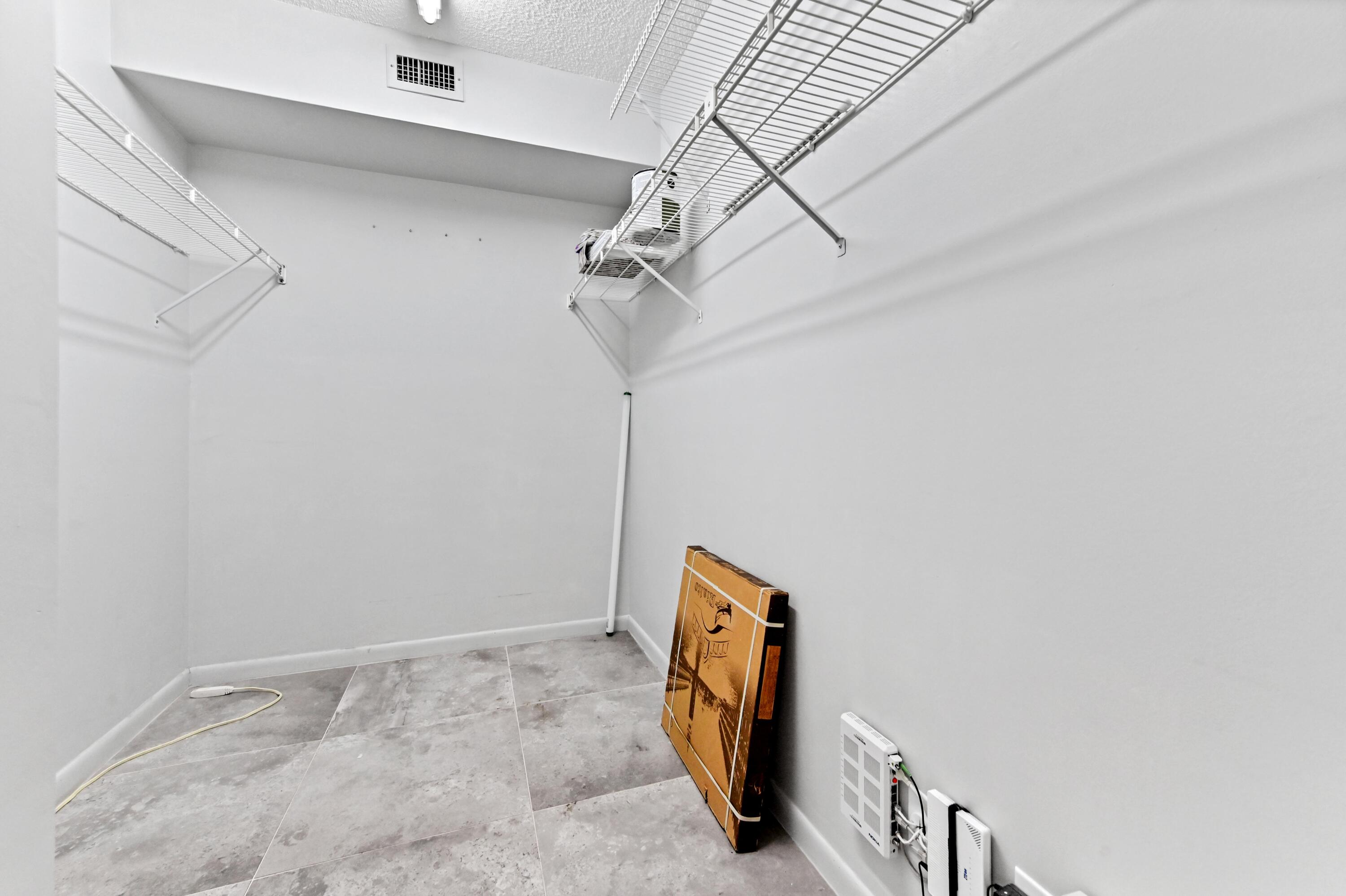 14895 Builtmore Way, Unit 107 Delray Beach, FL 33446 - Photo 9 of 40 a view of storage and utility room with stairs