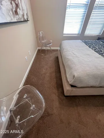 a bed with a small white comforter