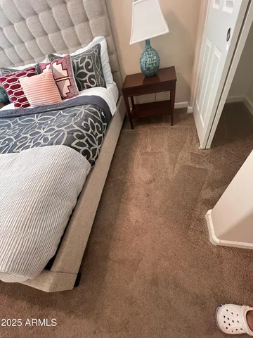 a bedroom with a bed lamp and a potted plant
