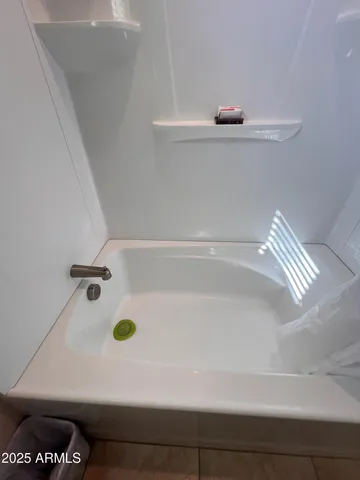 a bedroom with a bed and lamp