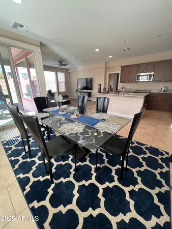 a view of an empty room and kitchen with furniture