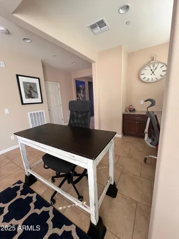 a view of a hallway with wooden floor and a bathroom